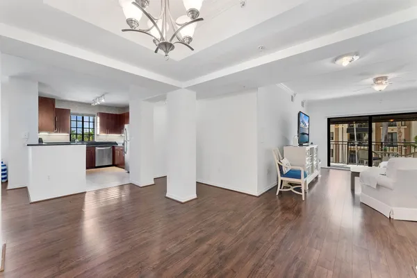 a kitchen with a dining table chairs and view living room