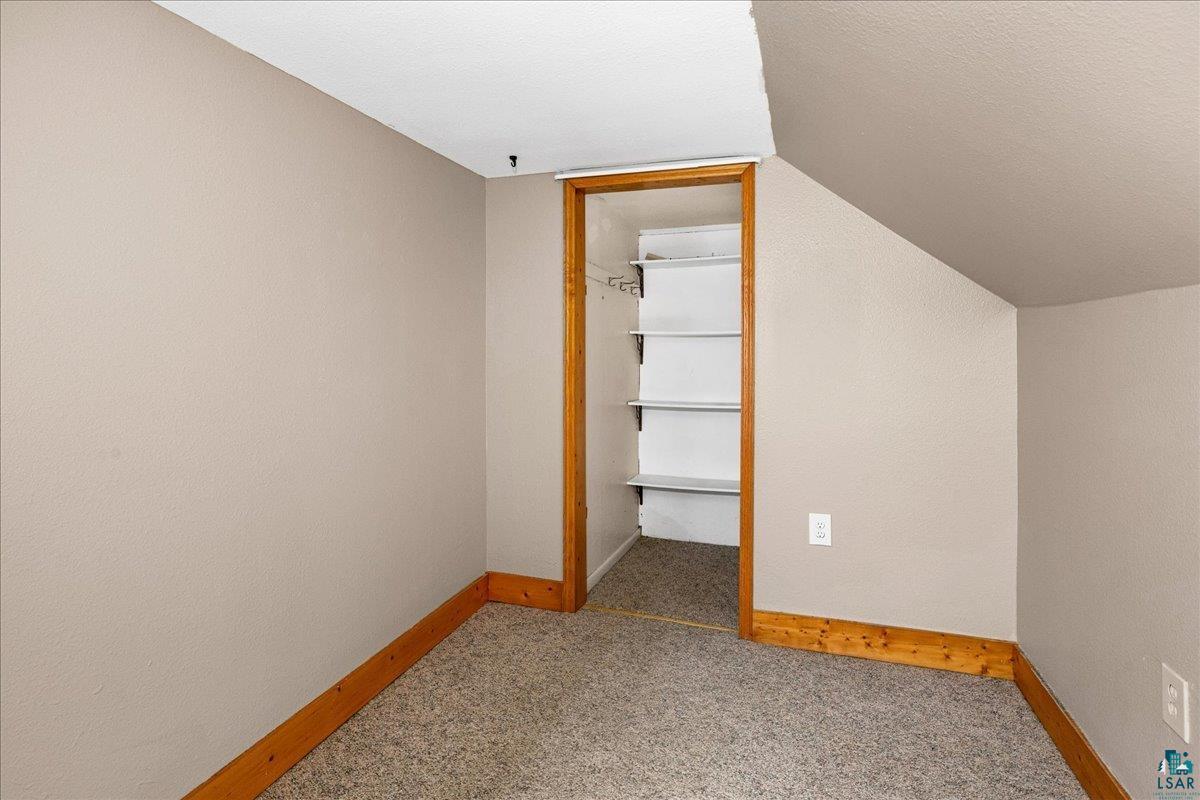 424 East Upham Road Duluth, MN 55811 - Photo 12 of 38 Carpeted room featuring a built-in closet with shelving and wood-finish trim