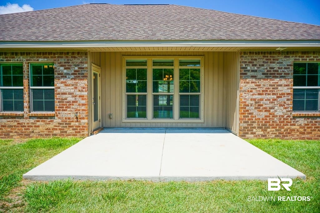 593 Begeman Road Mobile, AL 36608 - Photo 22 of 23 View of exterior entry with a yard and a patio