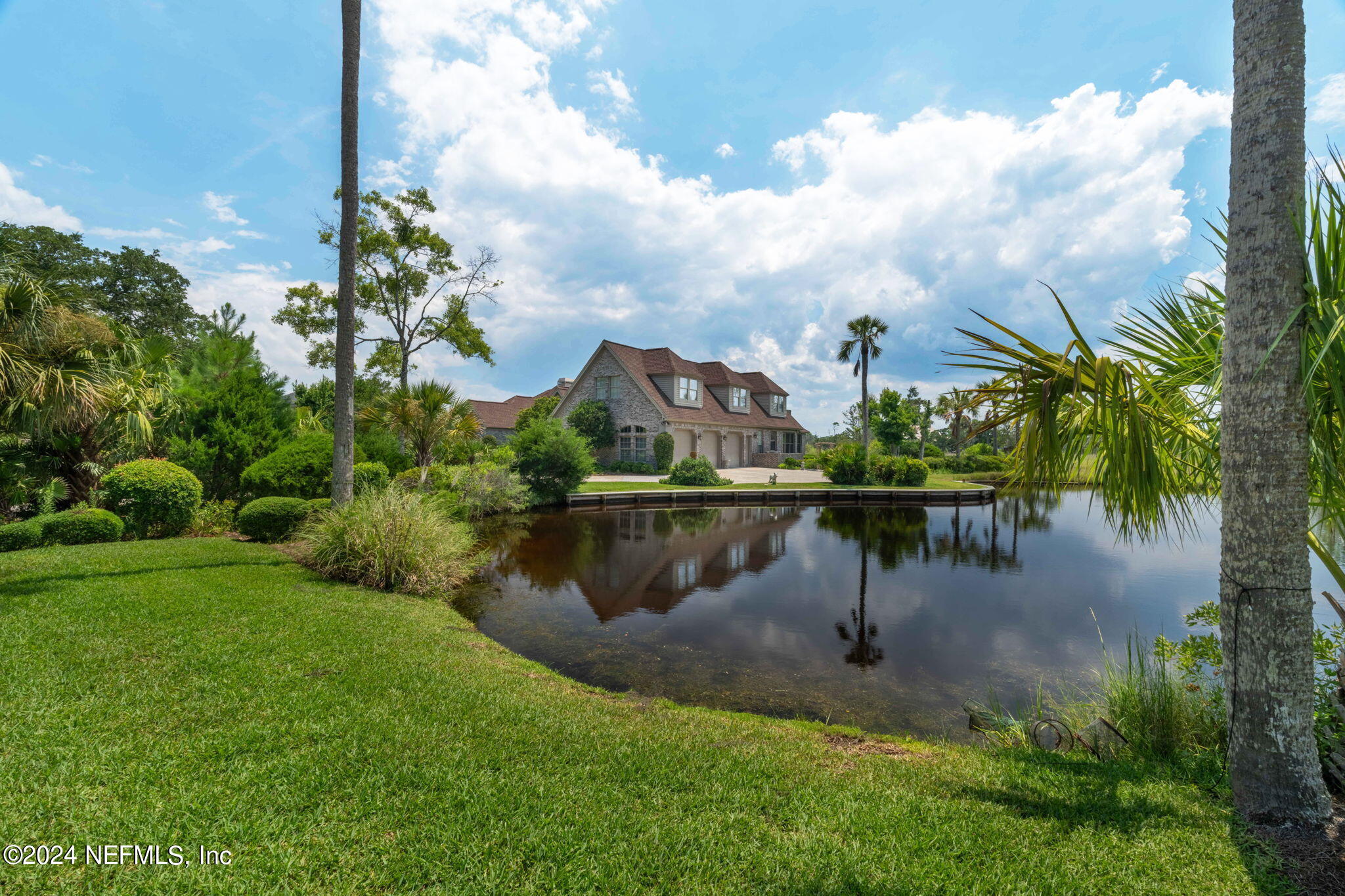 24629 Deer Trace Drive Ponte Vedra Beach, FL 32082 - Photo 27 of 45 a view of a lake with a garden