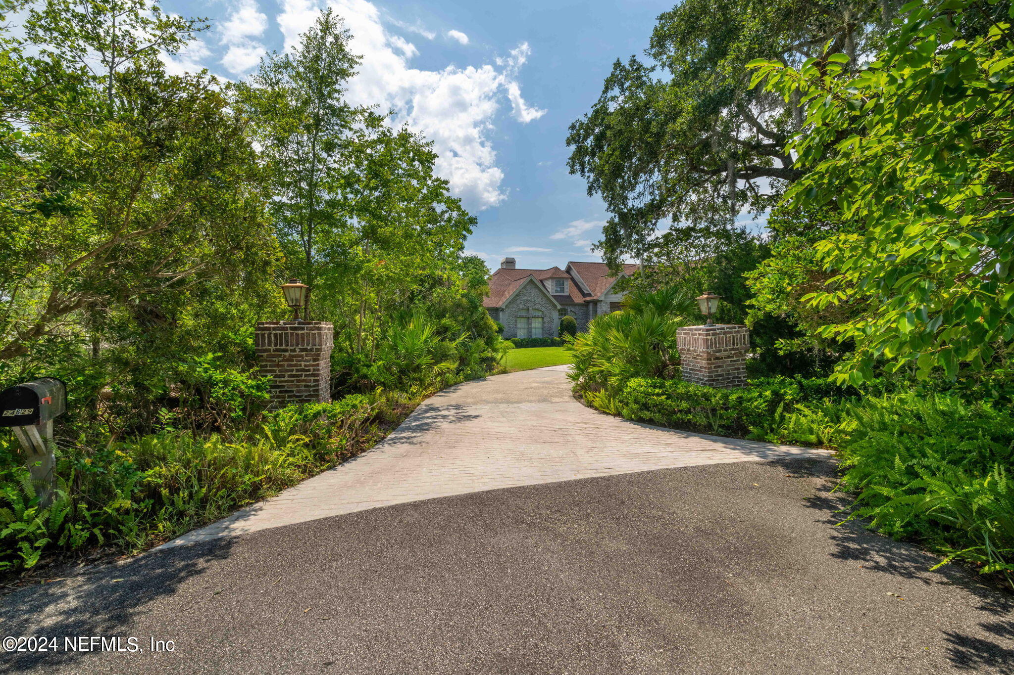 24629 Deer Trace Drive Ponte Vedra Beach, FL 32082 - Photo 28 of 45 a view of a street with flower plants and a small yard