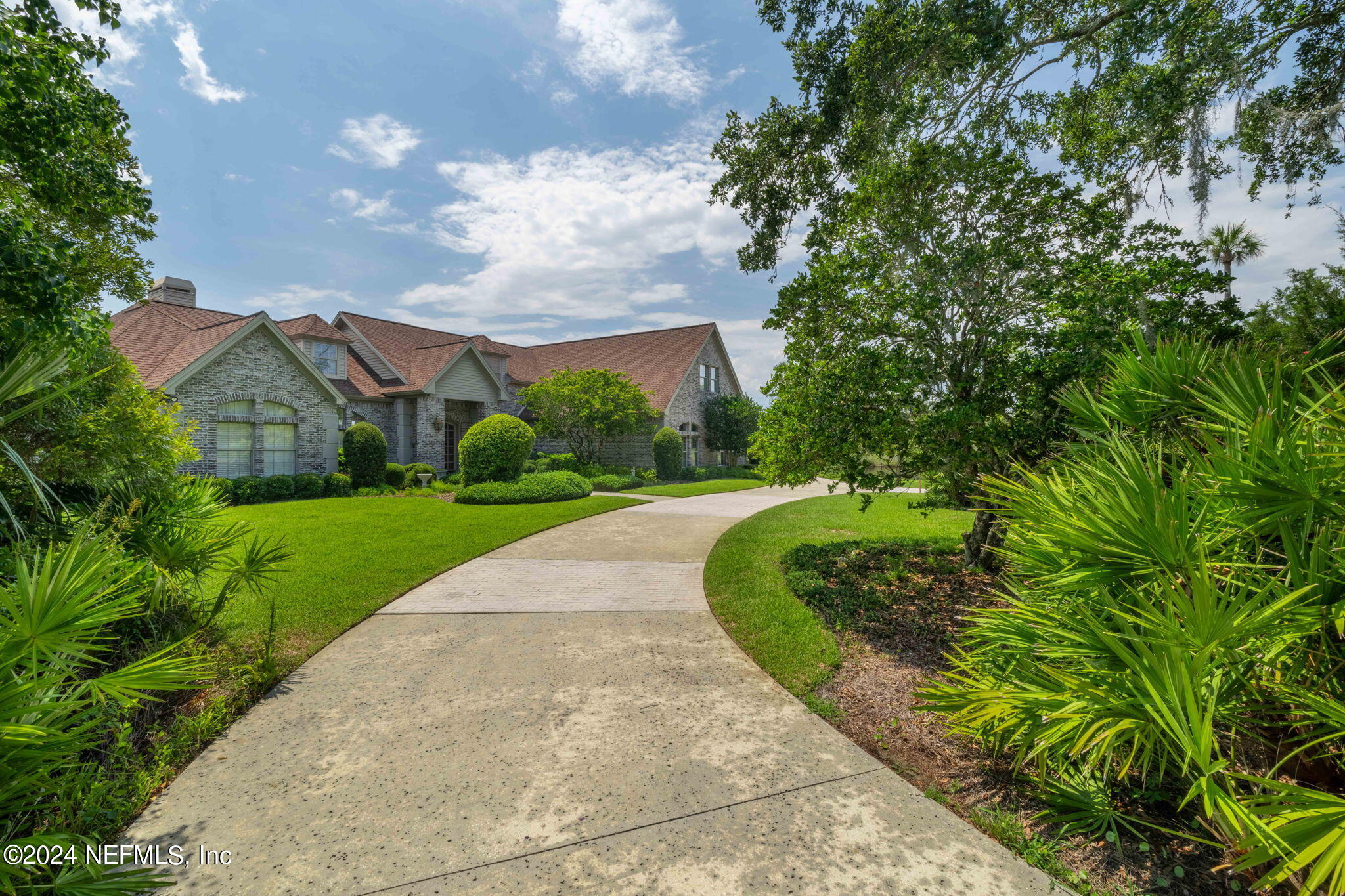 24629 Deer Trace Drive Ponte Vedra Beach, FL 32082 - Photo 29 of 45 a view of a garden with flower plants and wooden fence