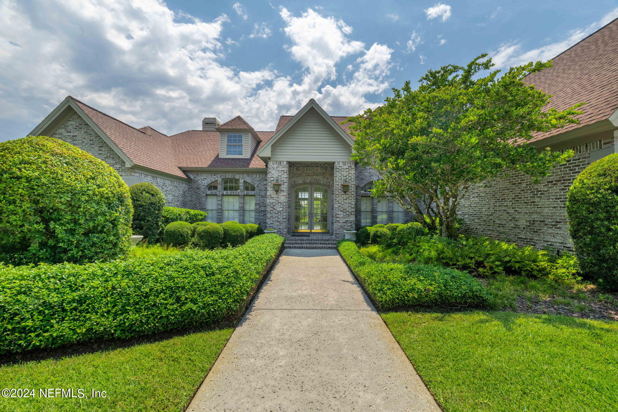 24629 Deer Trace Drive Ponte Vedra Beach, FL 32082 - Photo 4 of 45 a front view of a house with yard and green space