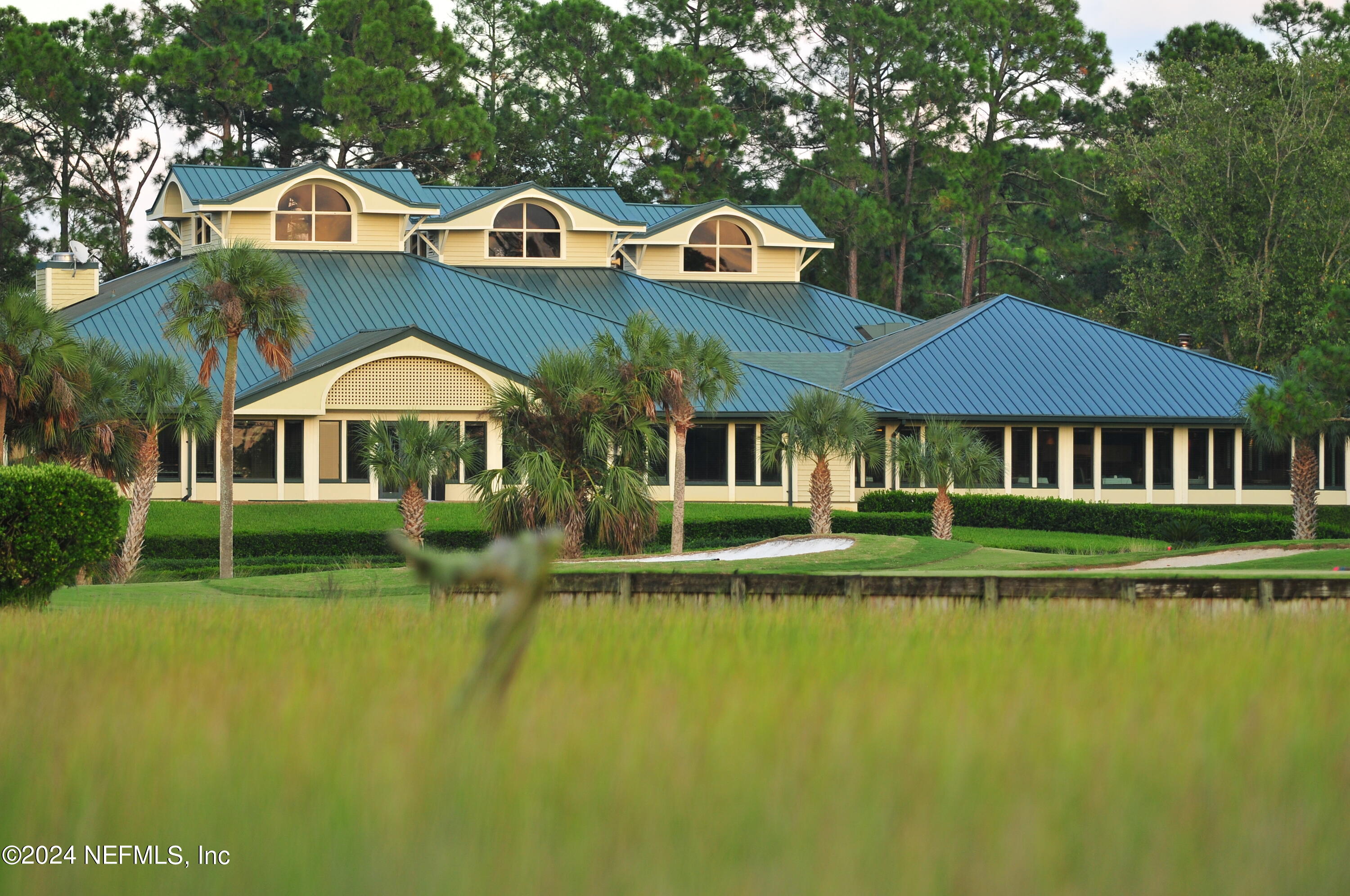 24629 Deer Trace Drive Ponte Vedra Beach, FL 32082 - Photo 43 of 45 a front view of a house with a yard table and chairs