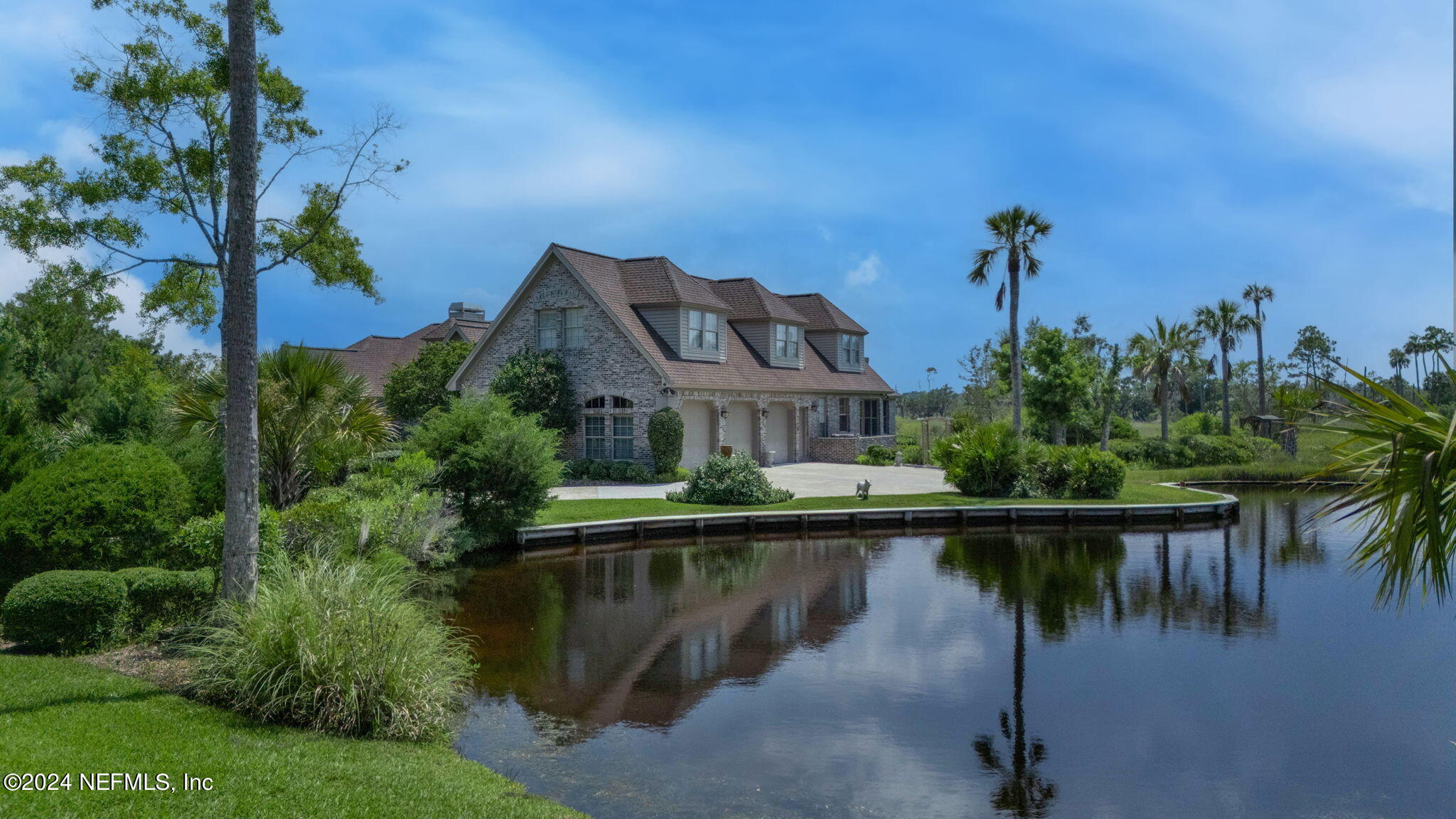24629 Deer Trace Drive Ponte Vedra Beach, FL 32082 - Photo 7 of 45 a view of a lake with a house in the background