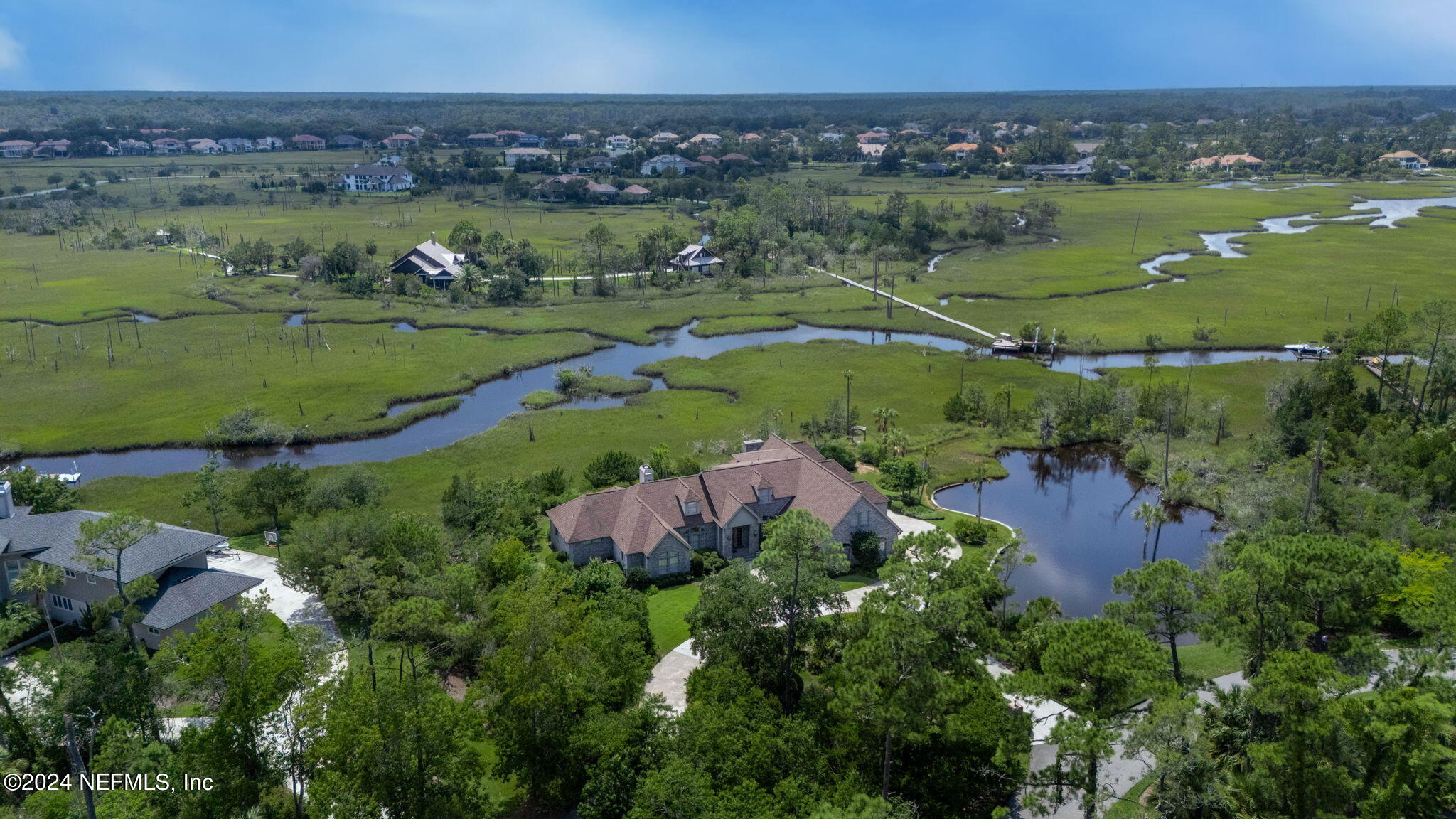 24629 Deer Trace Drive Ponte Vedra Beach, FL 32082 - Photo 10 of 45 an aerial view of green landscape with trees houses and lake view