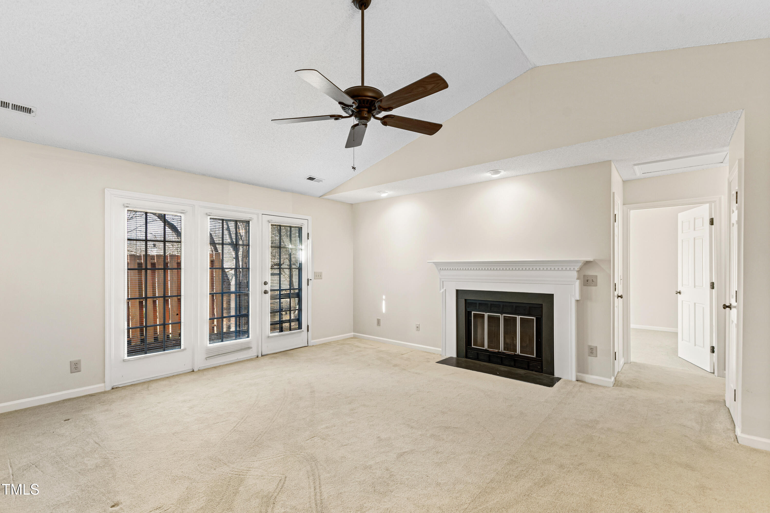 2615 Cottage Circle Raleigh, NC 27613 - Photo 13 of 27 a view of a livingroom with a fireplace and a ceiling fan