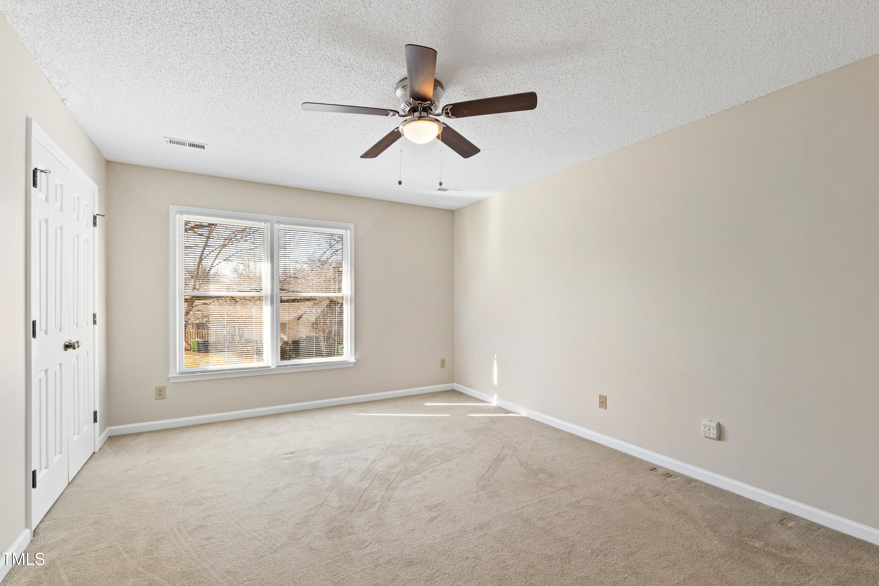2615 Cottage Circle Raleigh, NC 27613 - Photo 15 of 27 an empty room with windows and fan