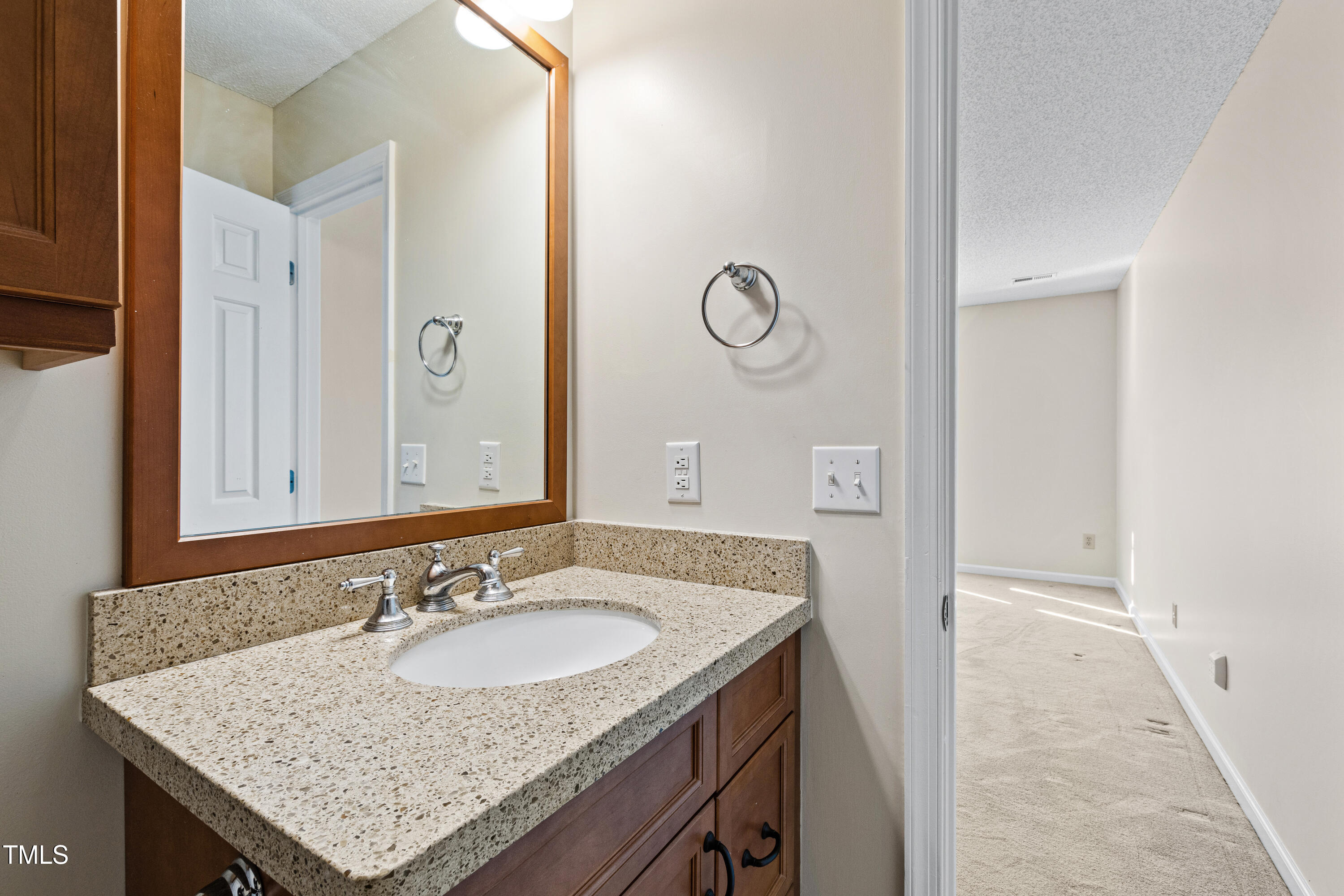 2615 Cottage Circle Raleigh, NC 27613 - Photo 17 of 27 a bathroom with a granite countertop sink and a mirror