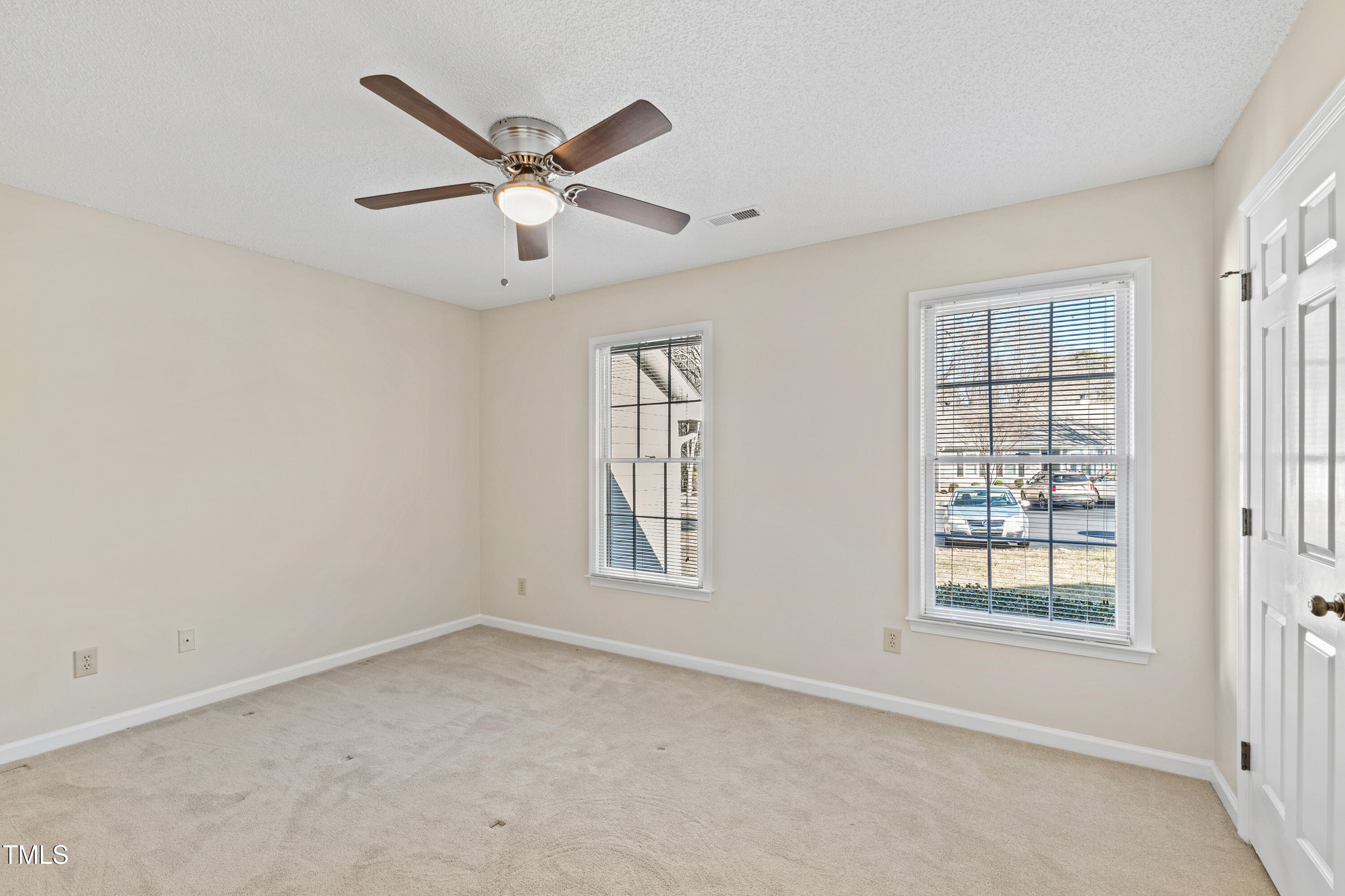 2615 Cottage Circle Raleigh, NC 27613 - Photo 19 of 27 a view of a livingroom with a ceiling fan & windows