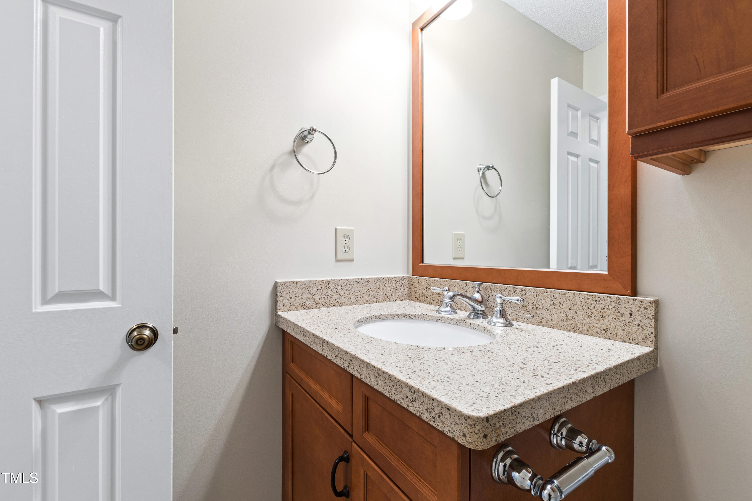 2615 Cottage Circle Raleigh, NC 27613 - Photo 21 of 27 a bathroom with a sink and a mirror