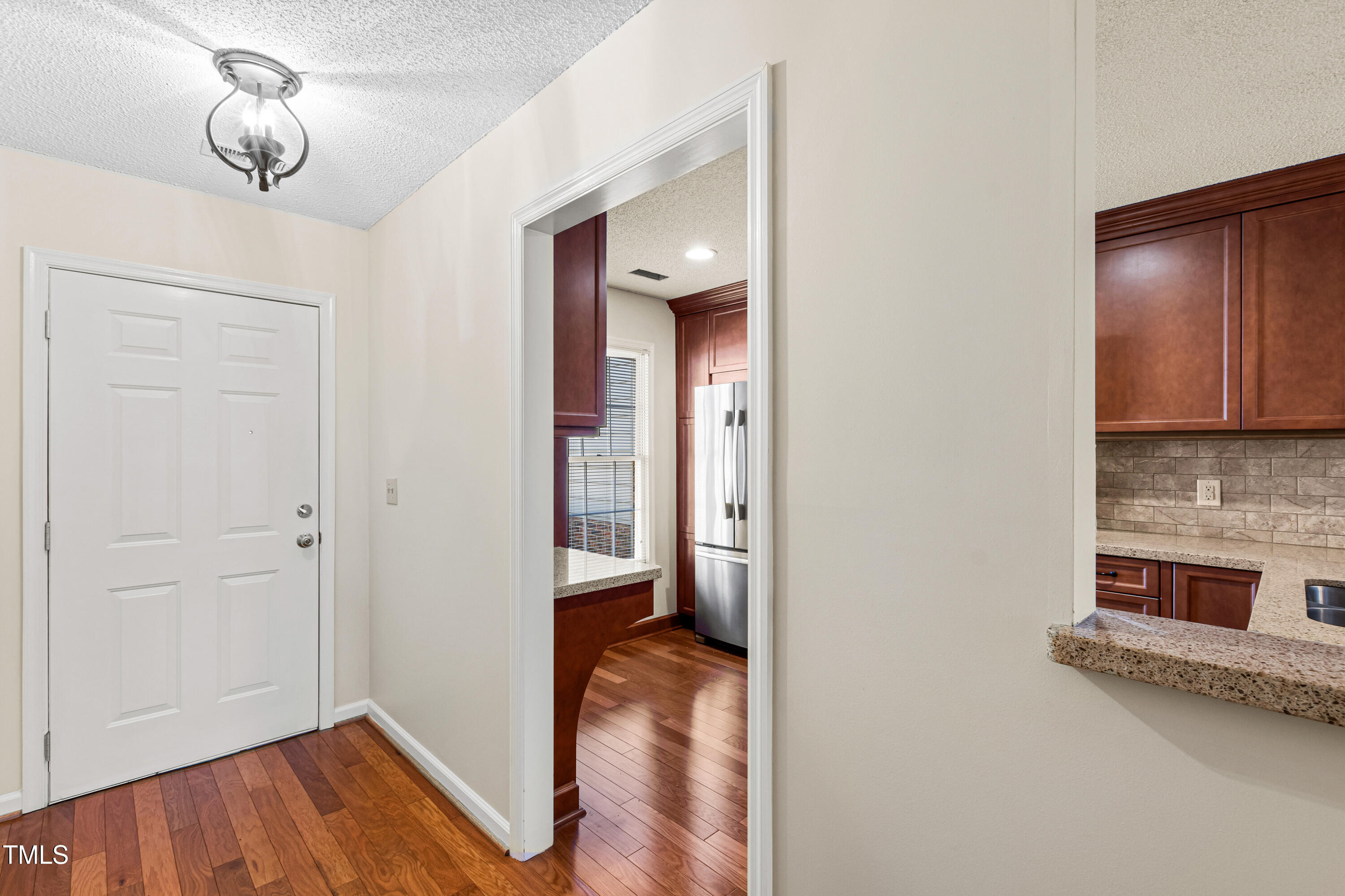 2615 Cottage Circle Raleigh, NC 27613 - Photo 4 of 27 a view of a hallway with wooden floor and staircase