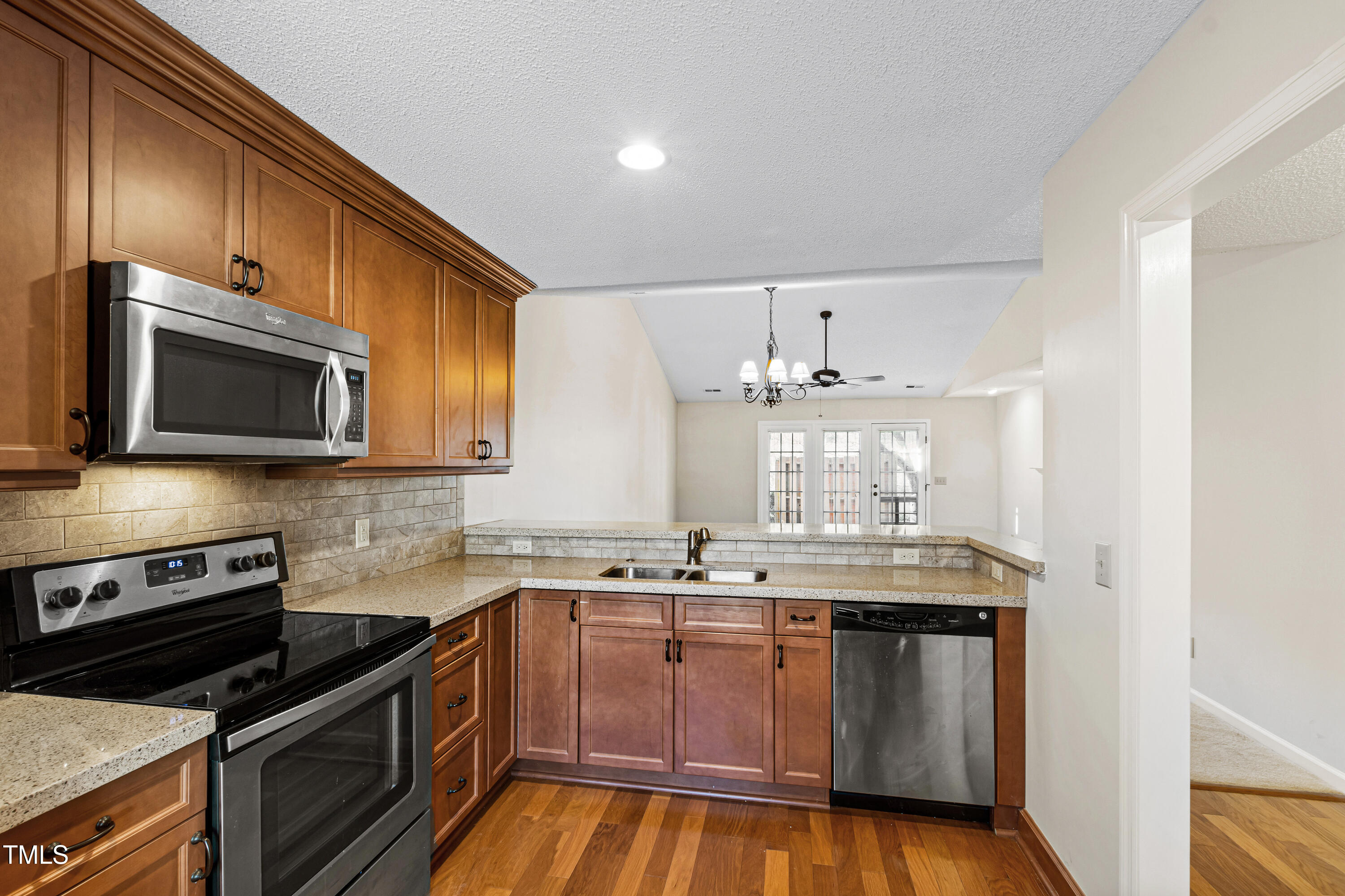 2615 Cottage Circle Raleigh, NC 27613 - Photo 6 of 27 a kitchen with stainless steel appliances granite countertop a stove a sink and a microwave