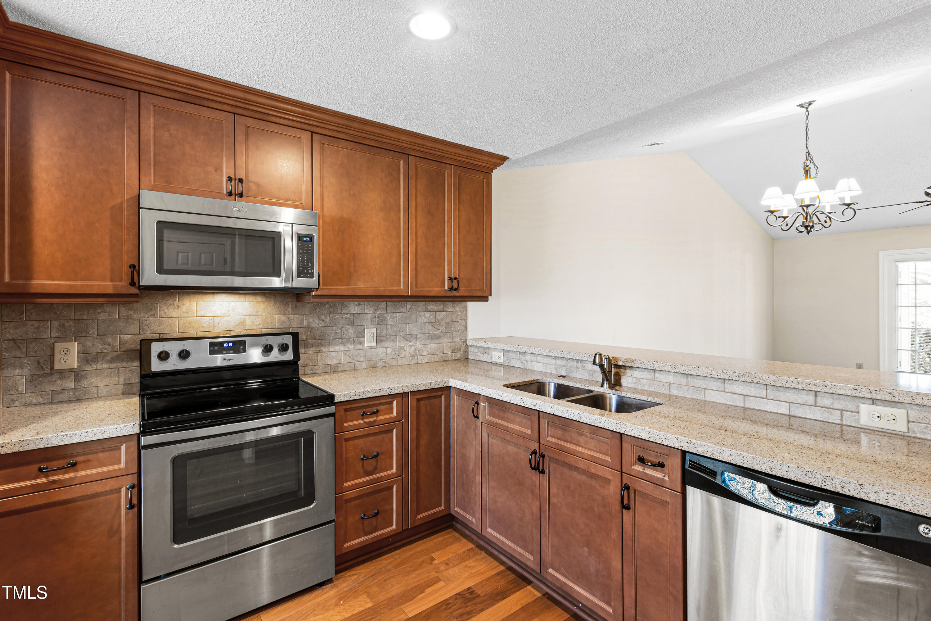 2615 Cottage Circle Raleigh, NC 27613 - Photo 7 of 27 a kitchen with a sink stove and microwave