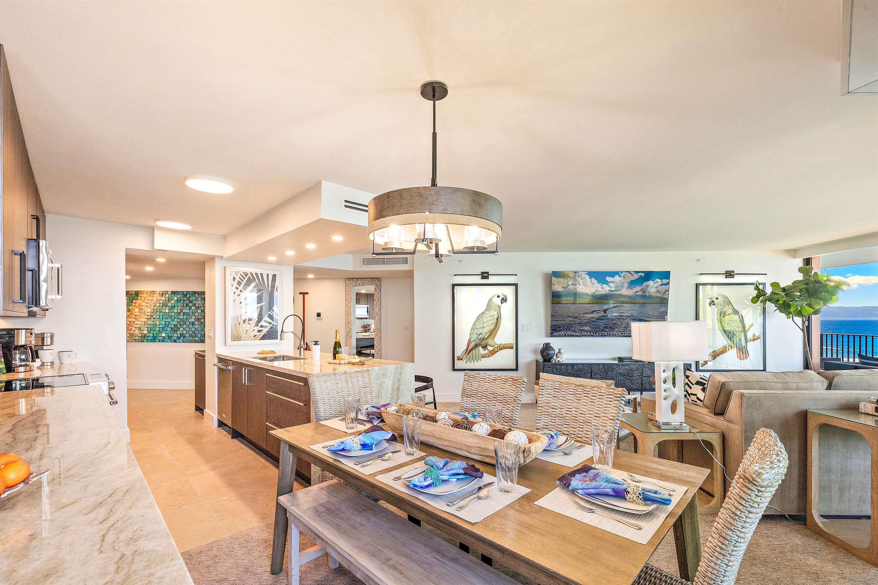 3445 Lower Honoapiilani Road, Unit 502 Lahaina, HI 96761 - Photo 21 of 50 a dining room with furniture a chandelier and wooden floor