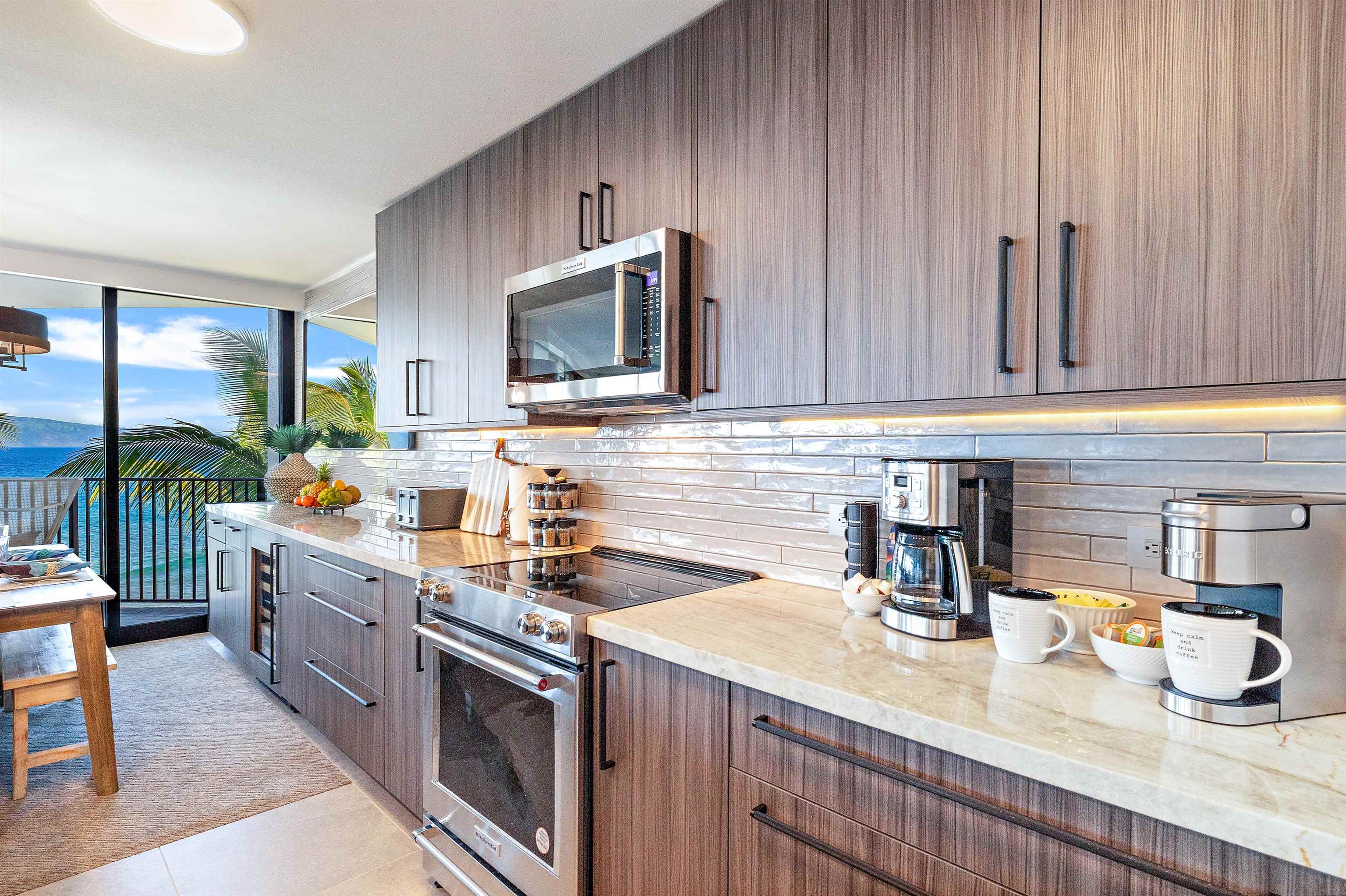 3445 Lower Honoapiilani Road, Unit 502 Lahaina, HI 96761 - Photo 7 of 50 a kitchen with sink cabinets and microwave