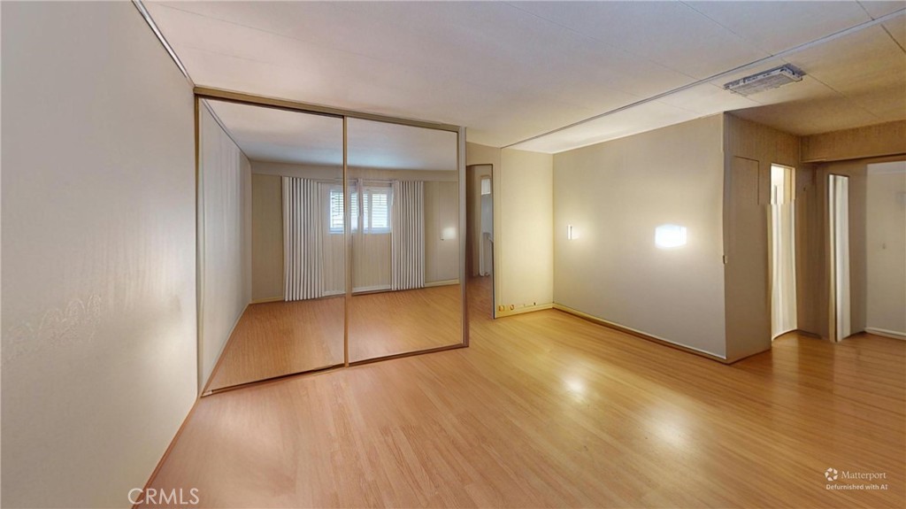 14851 Jeffrey Road, Unit 117 Irvine, CA 92618 - Photo 39 of 45 a view of an empty room with wooden floor and a window