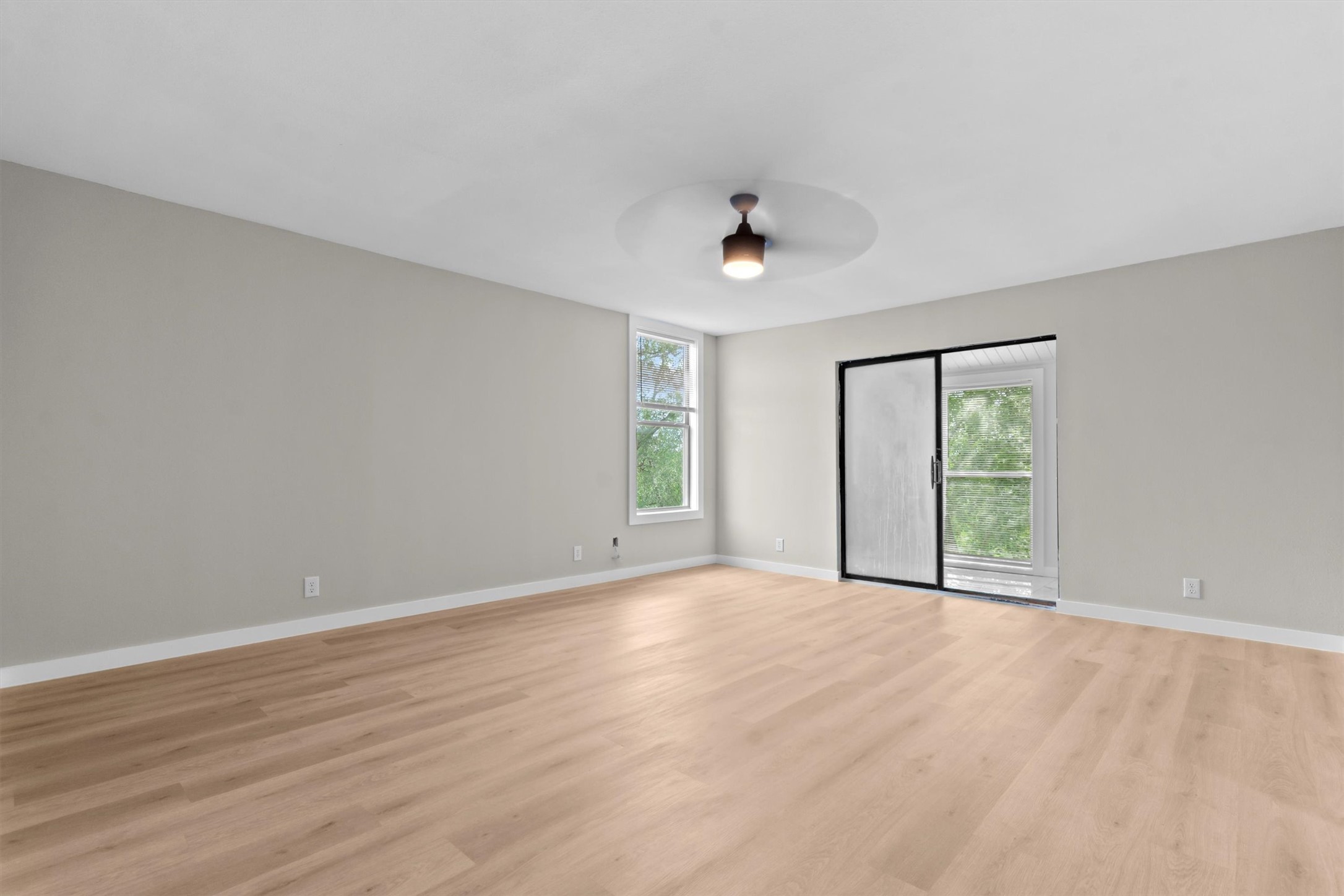 9100 Highway 183 Austin, TX 78747 - Photo 19 of 38 Warm wood flooring grounds this open interior, complete with a glass door to the balcony.