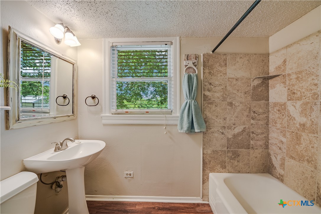 600 County Road 152 Georgetown, TX 78626 - Photo 11 of 24 a bathroom with a sink a toilet and shower