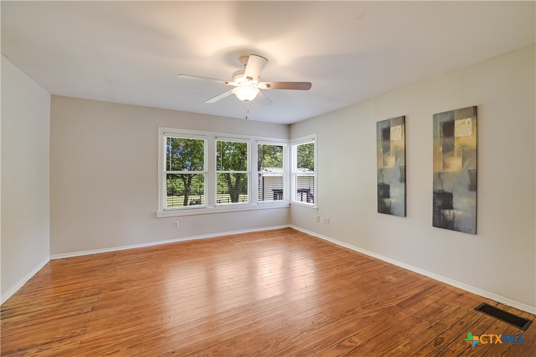600 County Road 152 Georgetown, TX 78626 - Photo 12 of 24 a view of an empty room with wooden floor and a window