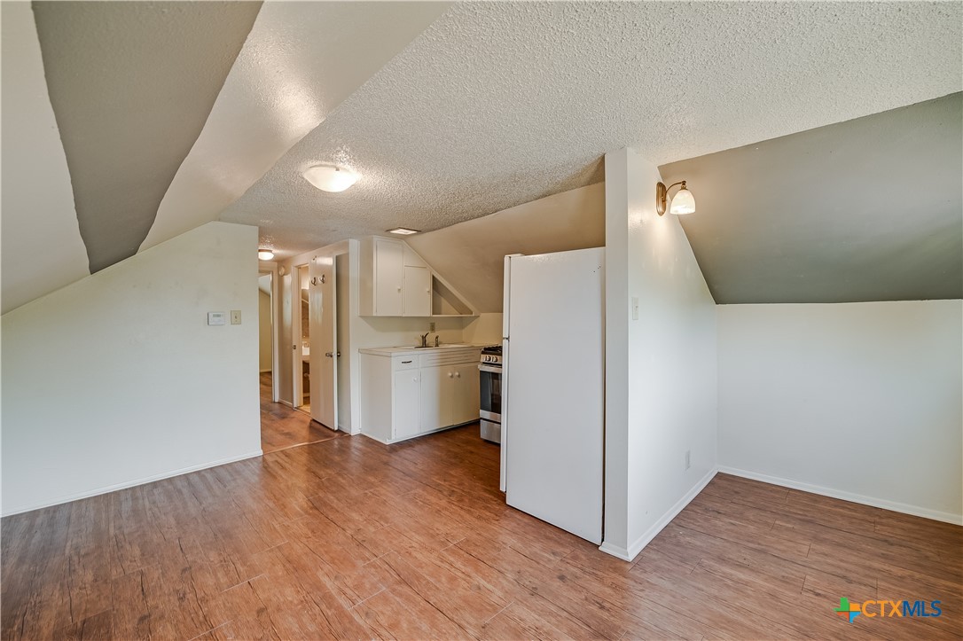 600 County Road 152 Georgetown, TX 78626 - Photo 18 of 24 a view of a kitchen with a refrigerator wooden floor and a kitchen