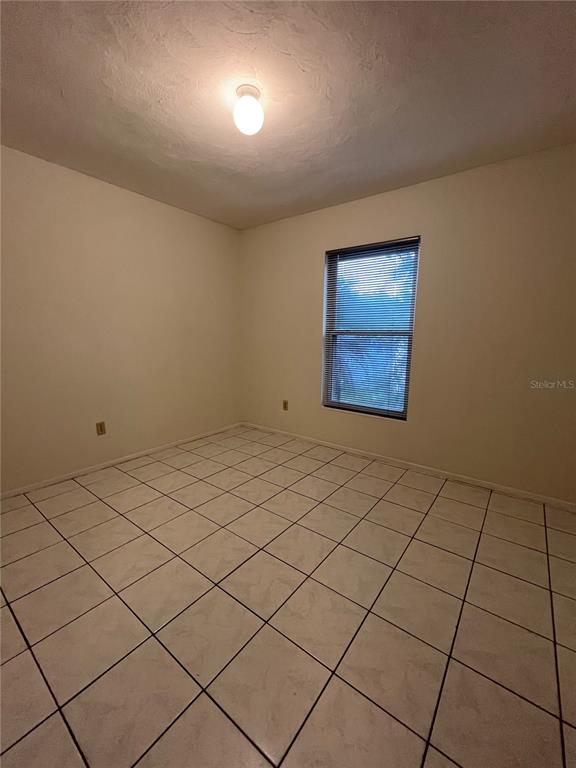 3222 Hammersmith Road Orlando, FL 32818 - Photo 12 of 17 a view of an empty room and wooden floor