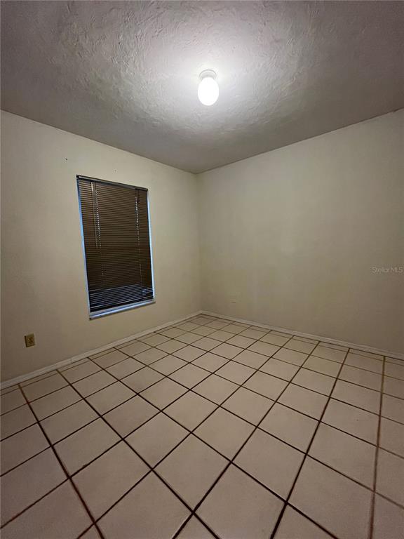 3222 Hammersmith Road Orlando, FL 32818 - Photo 15 of 17 a view of an empty room and wooden floor