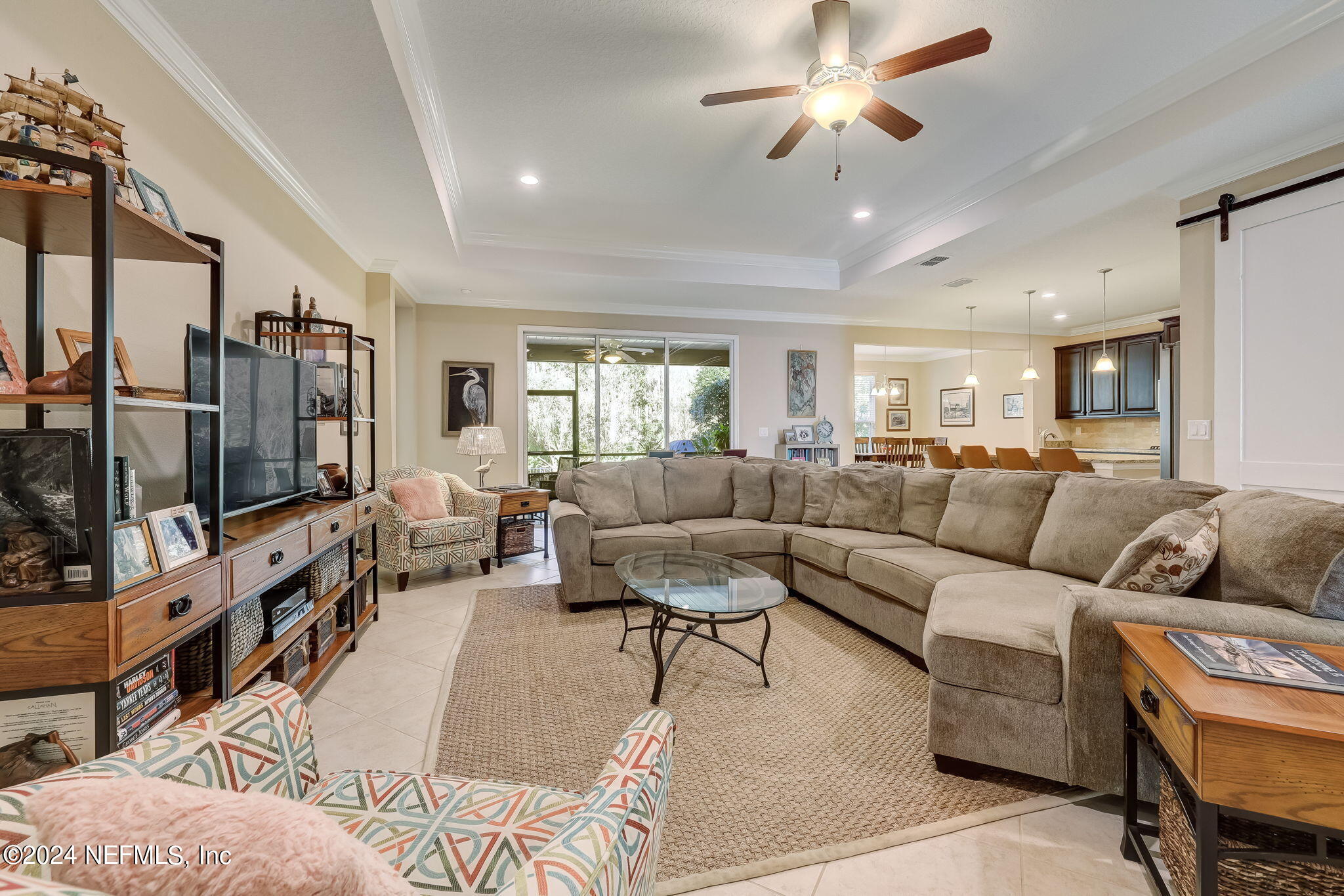 577 Aspen Leaf Drive Jacksonville, FL 32081 - Photo 1 of 106 a living room with furniture ceiling fan and a flat screen tv