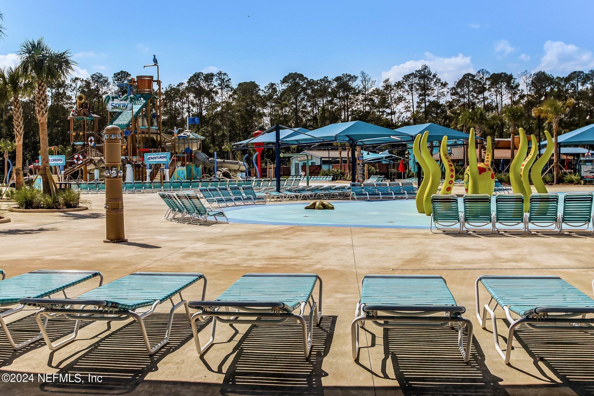 577 Aspen Leaf Drive Jacksonville, FL 32081 - Photo 104 of 106 a view of a patio with swimming pool table and chairs
