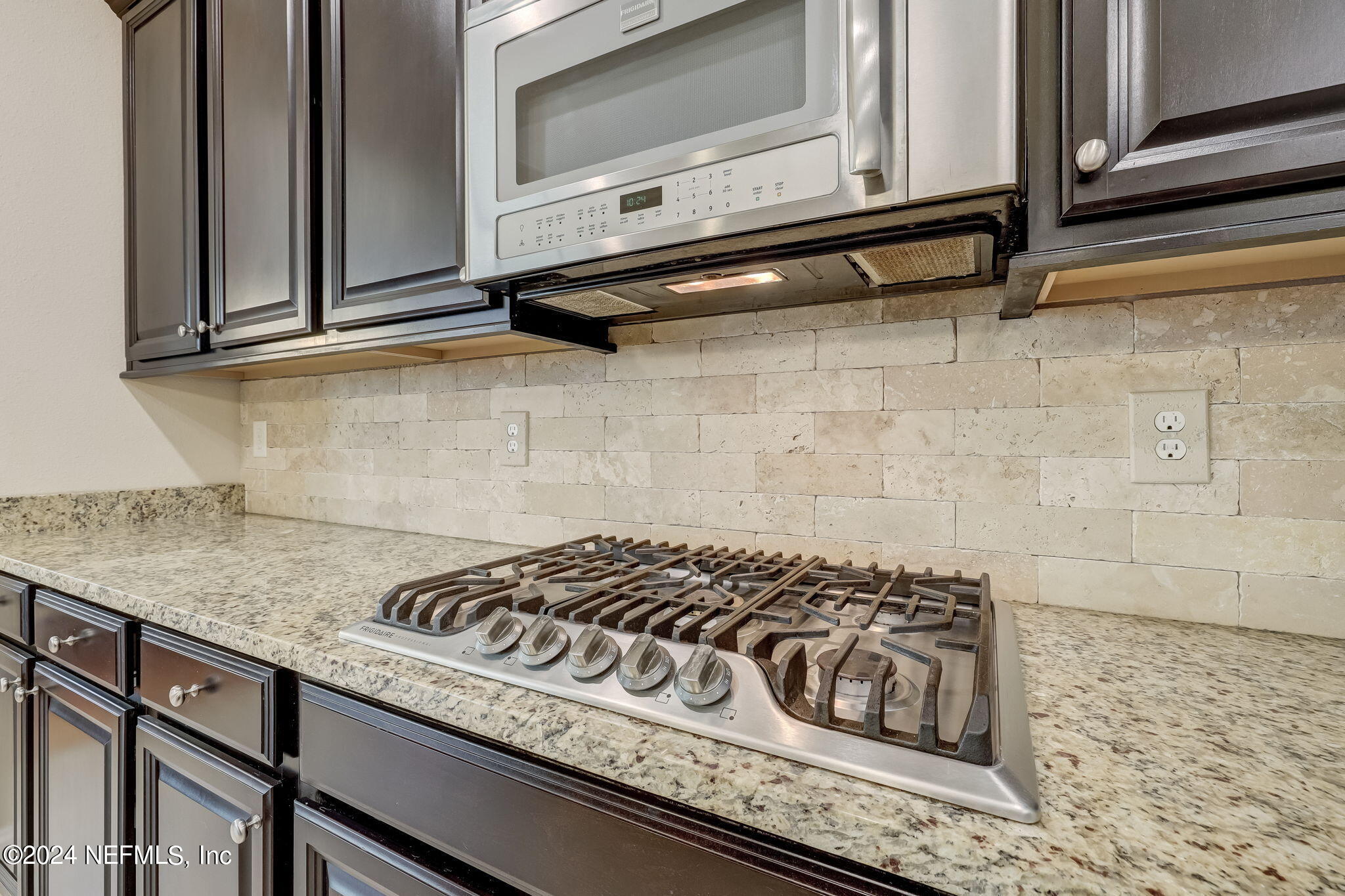 577 Aspen Leaf Drive Jacksonville, FL 32081 - Photo 11 of 106 a kitchen with granite countertop cabinets stove top oven and microwave