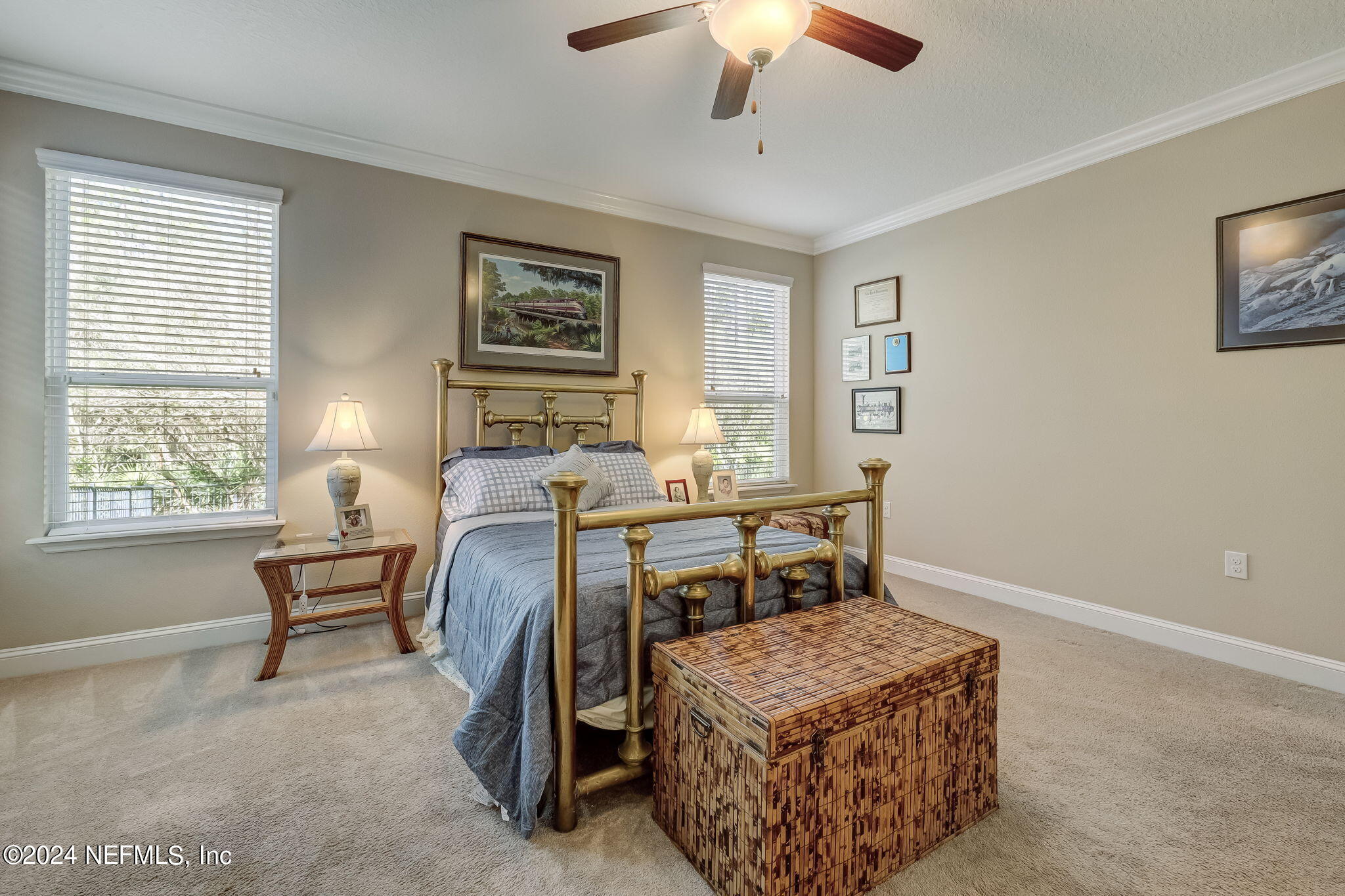 577 Aspen Leaf Drive Jacksonville, FL 32081 - Photo 18 of 106 a bedroom with a bed and a chandelier