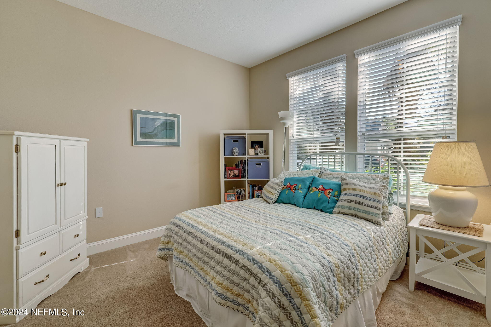 577 Aspen Leaf Drive Jacksonville, FL 32081 - Photo 27 of 106 a bedroom with a bed and a large window with book shelf