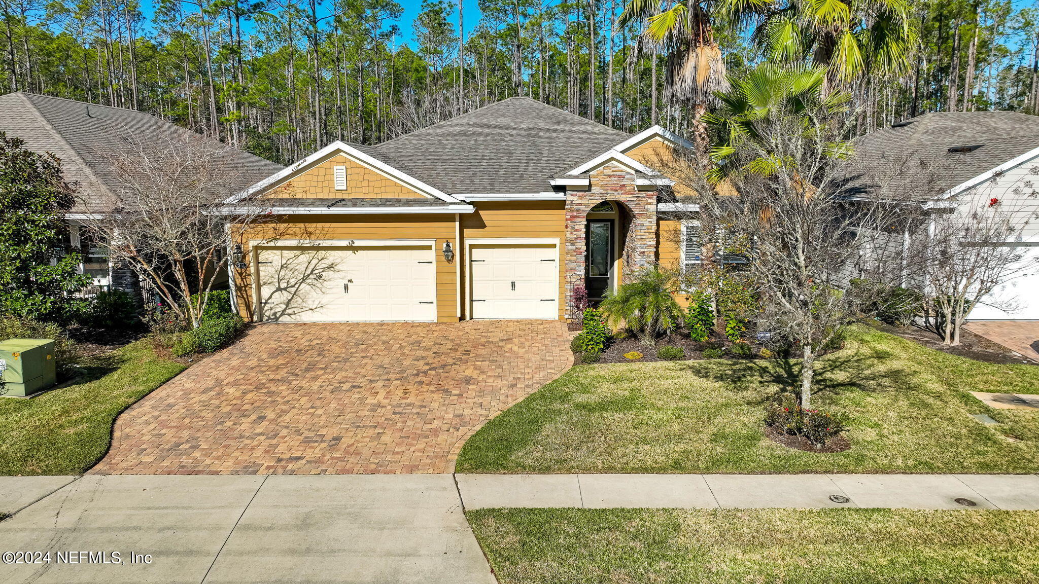 577 Aspen Leaf Drive Jacksonville, FL 32081 - Photo 35 of 106 a view of a white house next to a yard with big trees