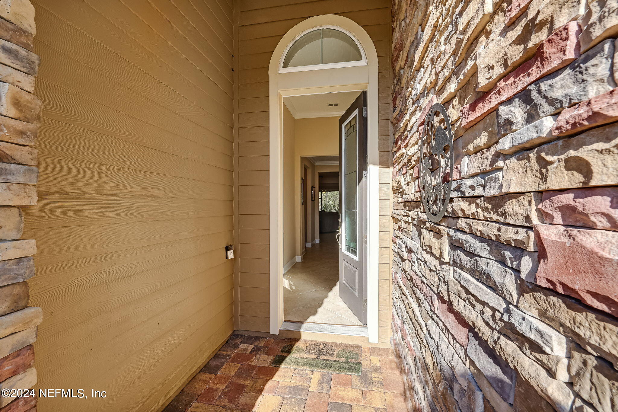 577 Aspen Leaf Drive Jacksonville, FL 32081 - Photo 4 of 106 a view of a brick house with a door and wooden floor