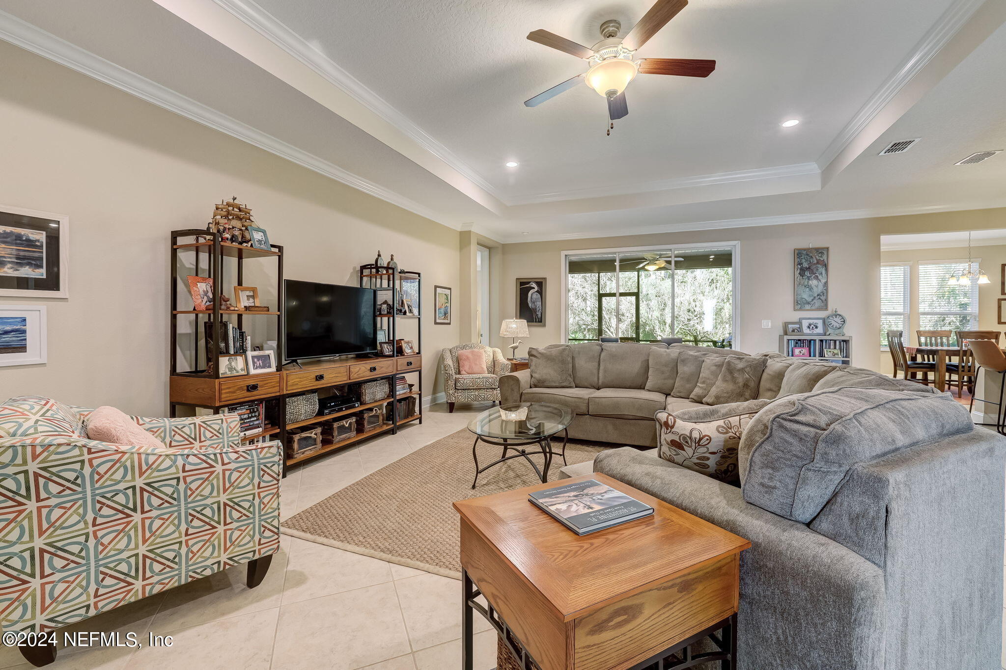 577 Aspen Leaf Drive Jacksonville, FL 32081 - Photo 6 of 106 a living room with furniture and a flat screen tv