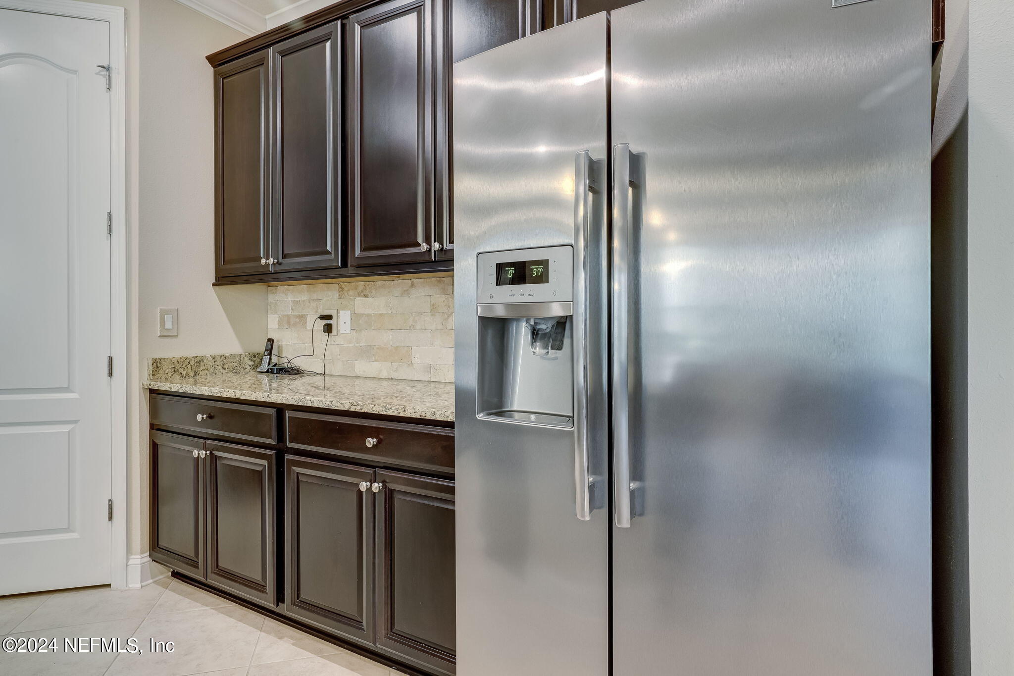 577 Aspen Leaf Drive Jacksonville, FL 32081 - Photo 9 of 106 a kitchen with stainless steel appliances granite countertop a refrigerator and a sink