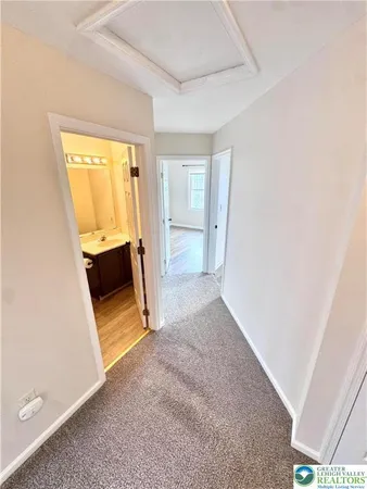 a view of a room with wooden floor and a sink