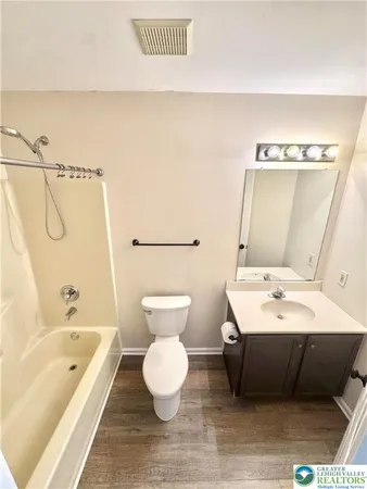 a bathroom with a sink a toilet and bathtub