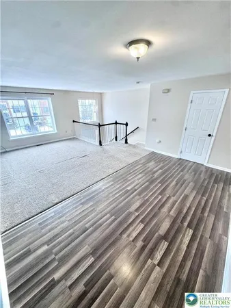 a view of a livingroom with wooden floor and window