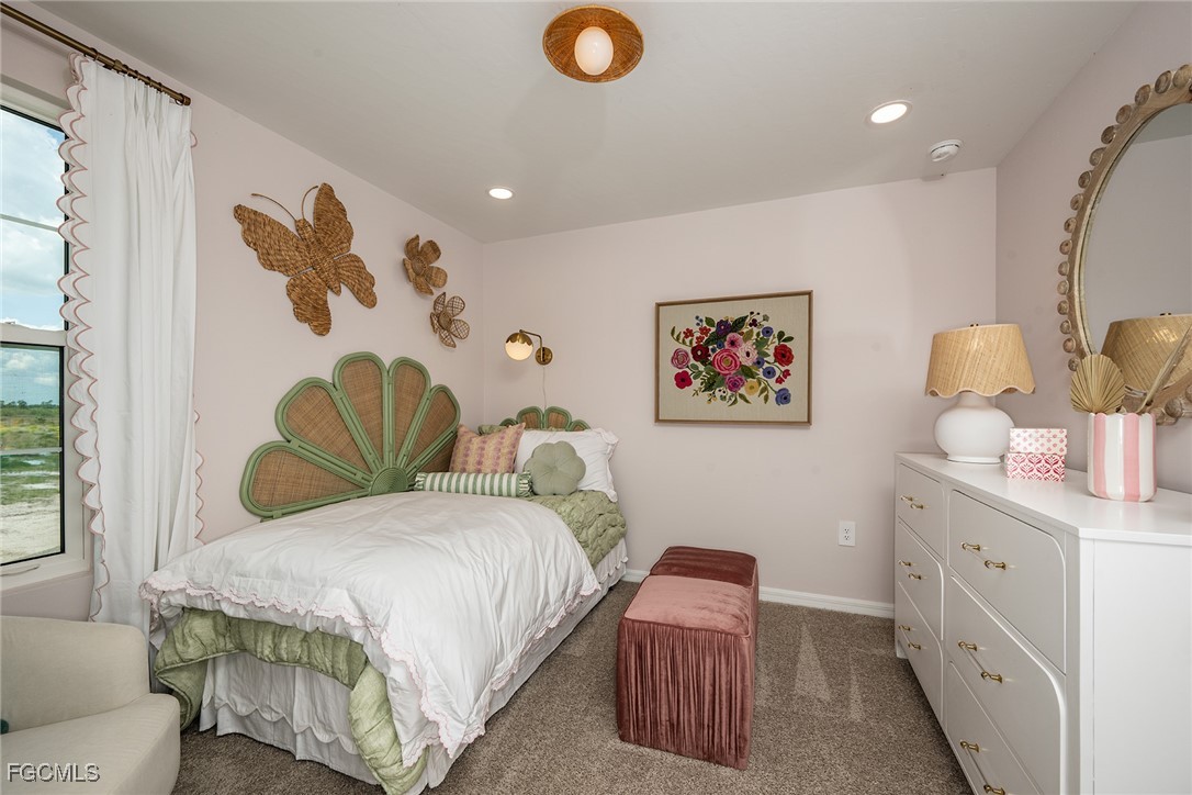 237 Moonlit Lk Trail Lehigh Acres, FL 33974 - Photo 12 of 18 a bedroom with a bed and a couch