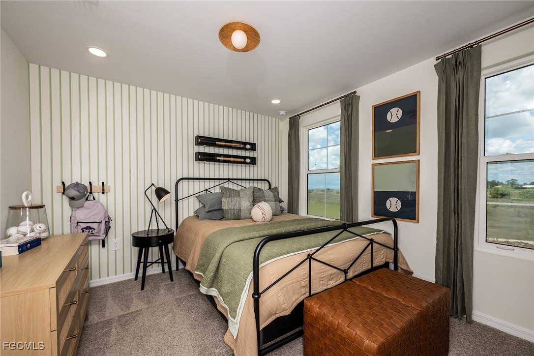 237 Moonlit Lk Trail Lehigh Acres, FL 33974 - Photo 13 of 18 a bedroom with a bed and a large window