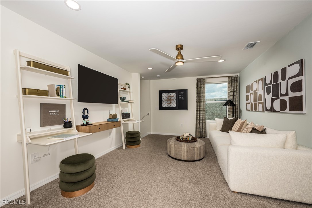 237 Moonlit Lk Trail Lehigh Acres, FL 33974 - Photo 10 of 18 a living room with furniture and a flat screen tv