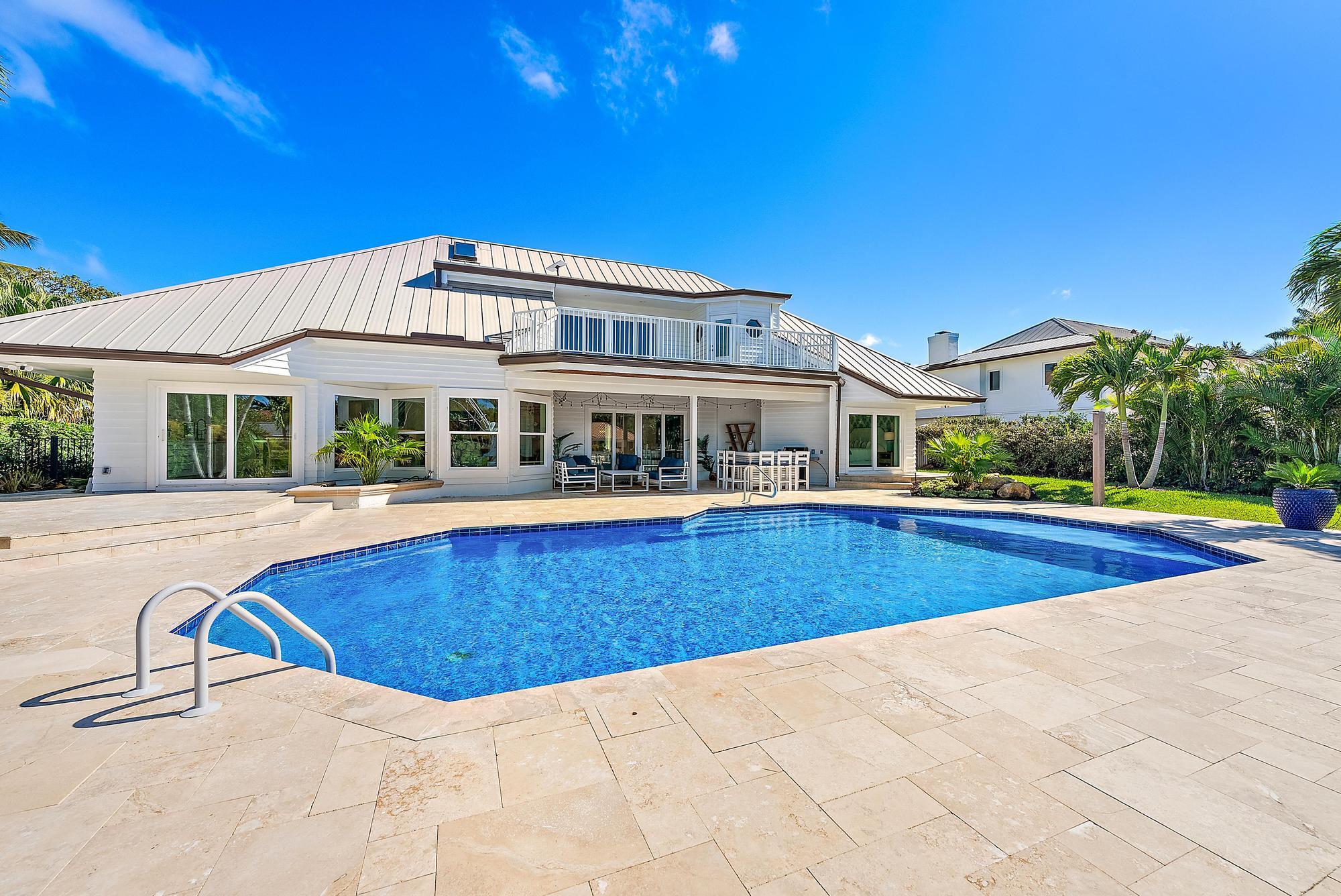 19 Island Road Sewall's Point, FL 34996 - Photo 41 of 50 a view of pool with large trees and wooden fence