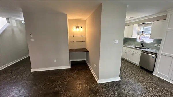 a kitchen with a sink and a refrigerator