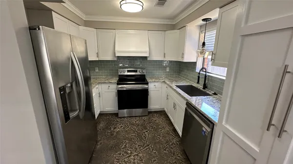 a kitchen with a refrigerator stove and sink