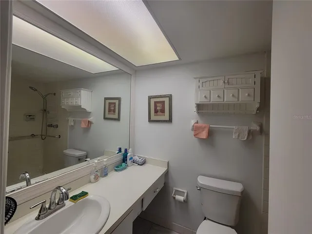 a white toilet sitting next to a bathroom sink