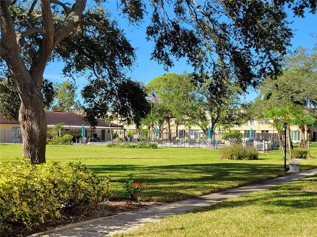 a view of a house with a yard and deck