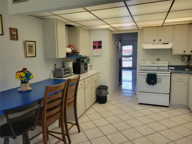 a kitchen with stainless steel appliances a refrigerator and a stove top oven