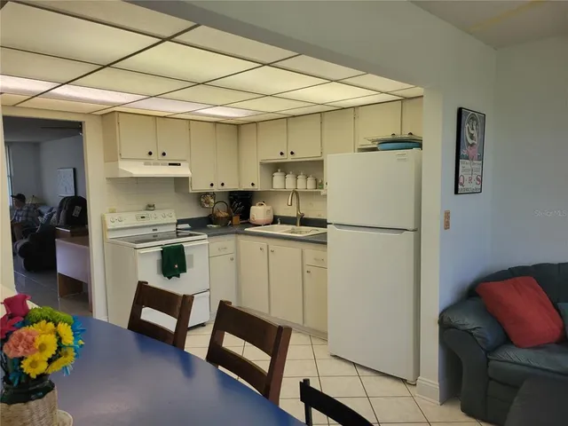 a white refrigerator freezer sitting inside of a kitchen