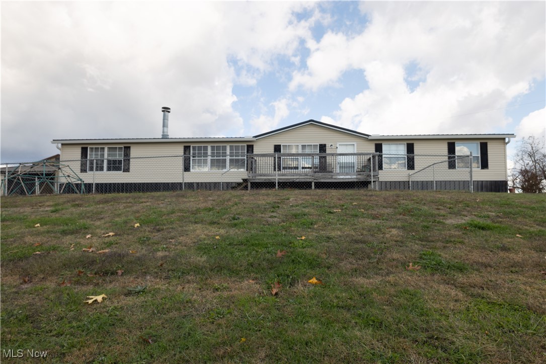 540 Wine Road Elizabeth, WV 26143 - Photo 2 of 49 Rear view of house featuring a wooden deck and a lawn